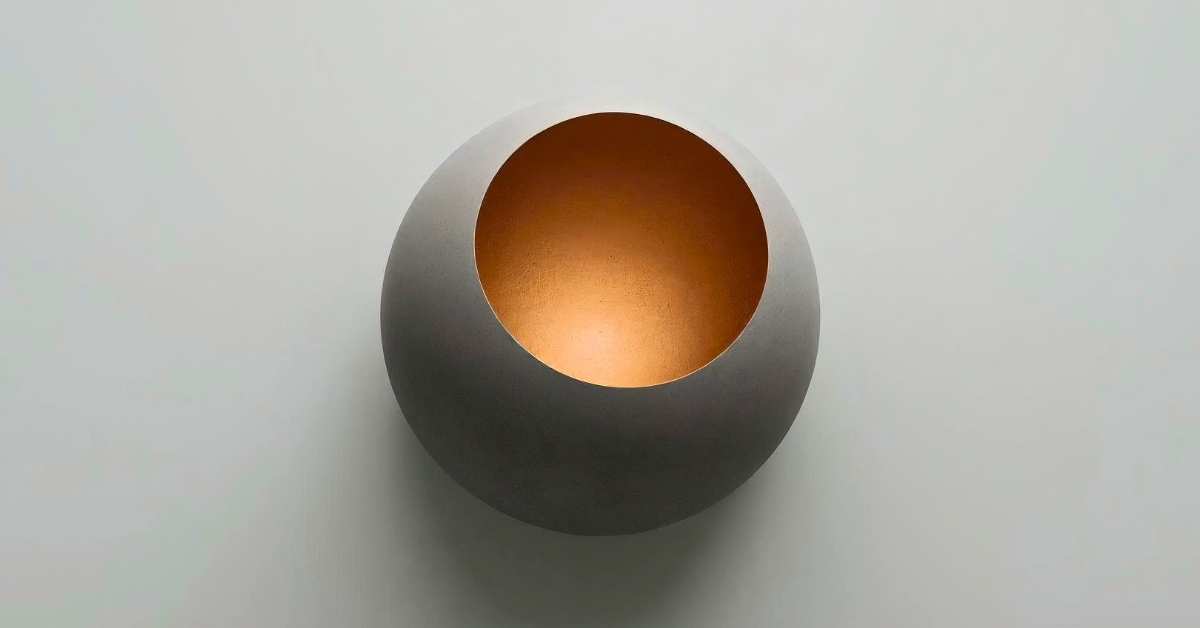 A rounded hollow vessel with a warm glowing interior, symbolizing containment holding inner light.